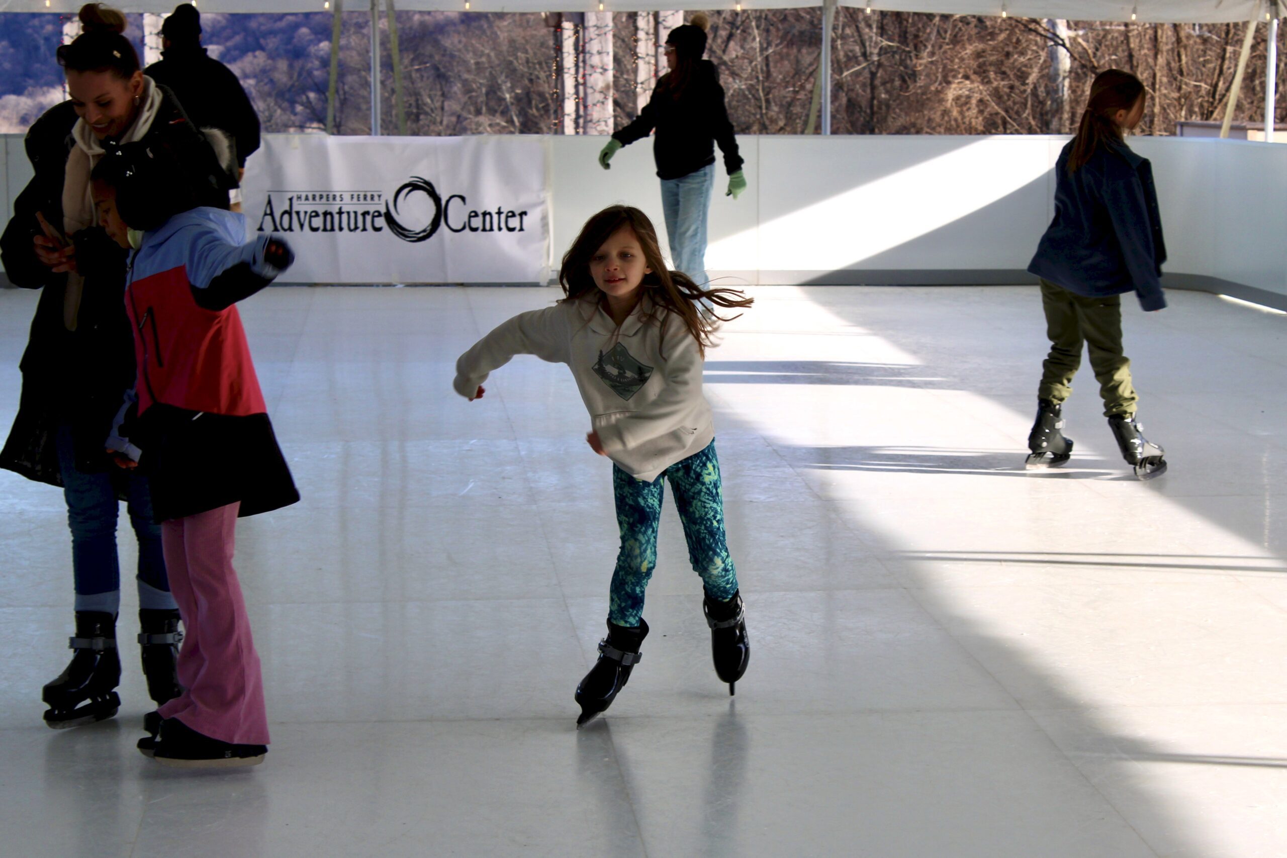 A girl skating on the synthetic ice rink at Harpers Ferry Adventure Center.